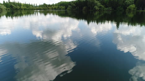 Hermoso-Vuelo-Sobre-Un-Lago-En-Francia.-Espejo-De-Agua-Reflejo-De-Las-Nubes